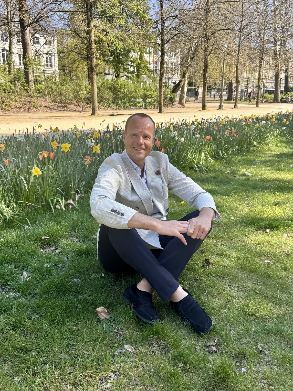 Kristjan Kann sitting on the grass in a park